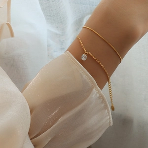 Double-layered 18k gold plated titanium bracelet with a sparkling zircon pendant