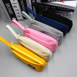 Detail view of colorful canvas pencil cases with double zippers and top handles