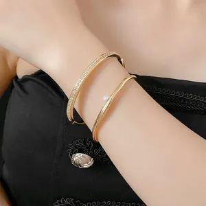Adjustable gold geometric bangles set with sparkling zircon pavé and white round pearl