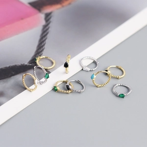 Macro view of assorted S925 sterling silver twist earrings with colorful gemstones