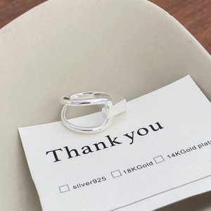 Detail of S925 sterling silver geometric double-loop ring on a thank you card