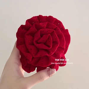 Detail view of a large red rose fabric scrunchie with delicate embroidered dots pattern