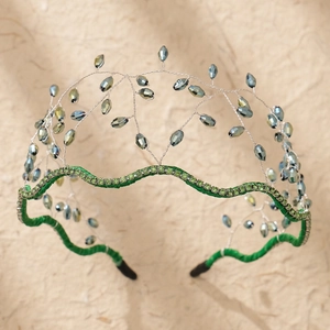 Detail of green mesh headband featuring blue crystals and silver handwoven wire design