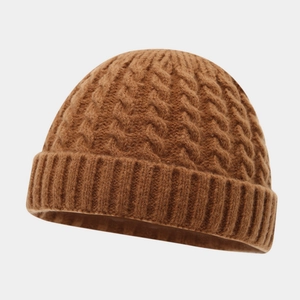 Detail of caramel brown cable knit beanie showing thick wool texture and ribbed cuff
