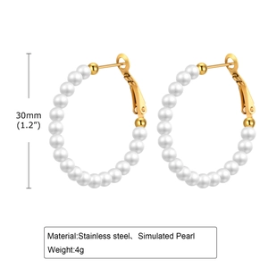Detailed close-up of 30mm gold stainless steel hoop earrings with elegant white pearls