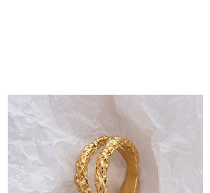 Macro shot of 18K gold plated ring with unique hammered texture and crumpled paper style