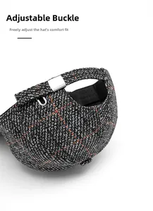 Macro detail of dark grey tweed baseball cap with adjustable silver metal buckle
