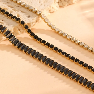 Detailed macro view of 18K gold plated tennis chains with black and white square stones