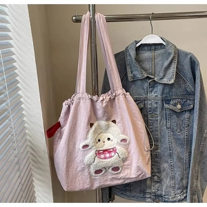 Detail of lavender canvas tote bag featuring a cute 3D plush sheep patch decoration