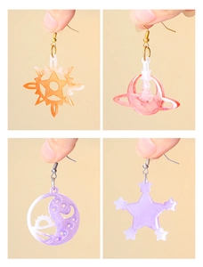Detail shots of star and moon acrylic earring charms with glitter finish in warm tones