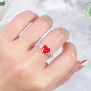S925 sterling silver heart-shaped pink diamond ring with small side stones on a finger