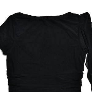 Close-up detail of black mesh fabric with elegant back pleats and ruched texture on the waist