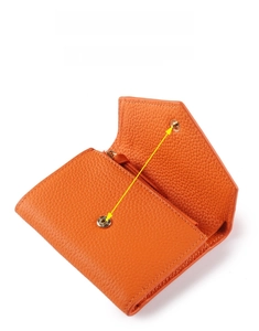 Detail of orange lychee grain leather wallet with a secure metal snap and zipper pocket