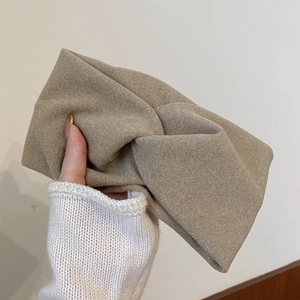 Knitted khaki knot headband with thick woolen texture for a stylish autumn winter look