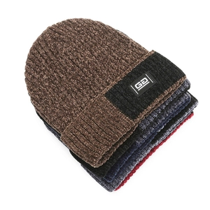 Close-up of stacked winter chenille beanies in various colors with G2 woven label