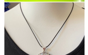 Detailed view of silver hollow hexagram pendant with star center on a model