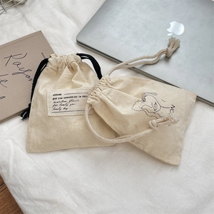 Set of two cotton canvas drawstring bags with minimalist line art and fabric labels