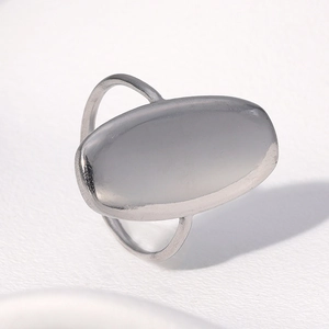 Close-up of a minimalist silver stainless steel ring with a smooth oval flat top design
