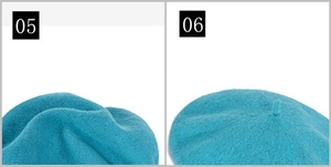 Detailed top view of a dark teal wool beret featuring the stem and textured knit pattern