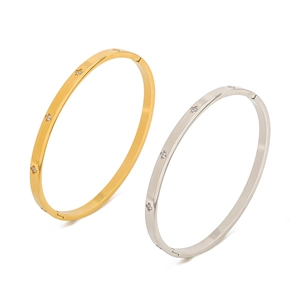 Gold and silver stainless steel bangles with star-shaped zircon inlays on white background