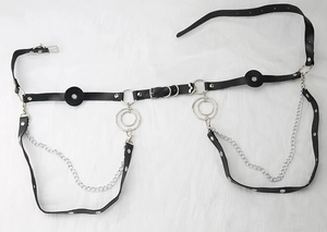 Detail of gothic black leather body harness with silver chains and metal O-ring buckle