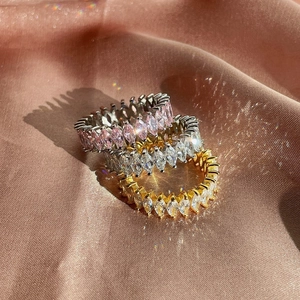 Three marquise-cut eternity rings in silver and gold with pink and white zircon gems