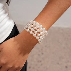 Detail of five-row faux pearl bracelet with sparkling rhinestone-set metallic spacers