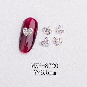 Macro detail of 7x6.5mm heart shaped iridescent nail art crystal charms for DIY manicures