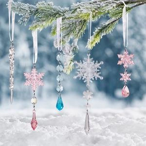 Clear, pink, and blue acrylic Christmas icicle and snowflake ornaments on snow-covered pine
