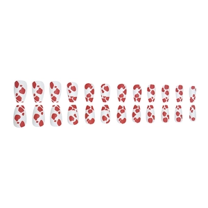 Set of 24 red and white cow print press-on nails in long coffin shape on white background
