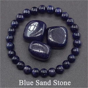 Detail of blue sand stone beaded stretch bracelet with polished sparkling raw stones