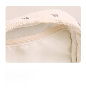 Detail of internal mesh zipper pocket for organized storage in corduroy cosmetic bag