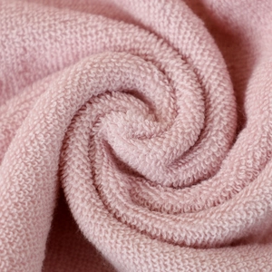 Macro shot of soft pink 32-strand cotton children towel showing plush fiber texture