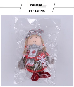 Detailed view of a Christmas gnome doll ornament in its transparent protective packaging