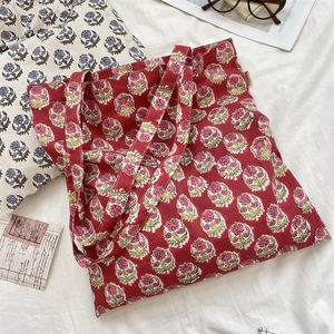 Detailed close-up of retro floral canvas tote bag with vintage woodblock flower prints