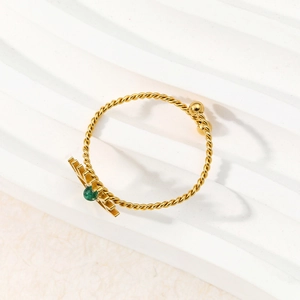 Adjustable golden twisted rope evil eye ring with green natural stone setting