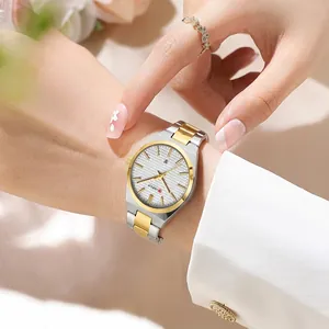 Close-up of a two-tone steel ladies watch on wrist with a date window and floral decor