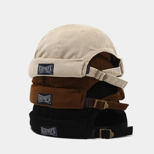 Vintage corduroy docker hats in beige, brown, and black with adjustable metal buckles
