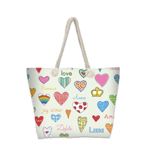 Detailed view of canvas tote bag with colorful heart prints and multi-language love text