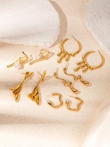Detailed view of assorted gold titanium steel vintage floral and heart earrings set
