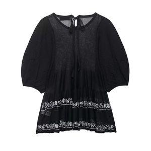 Women's black linen blouse with puff sleeves and white floral embroidery detail