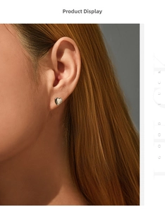 Close-up of minimalist S925 sterling silver heart stud earrings with sparkling stones