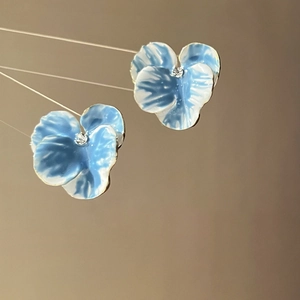 Blue and white gradient flower stud earrings with a sparkling rhinestone center