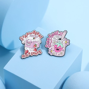 Pink strawberry milkshake and soda enamel pin set on a light blue geometric platform