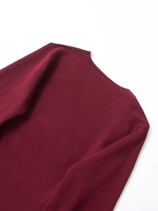 Detail view of the ribbed neckline on a burgundy long sleeve knitted cardigan with belt
