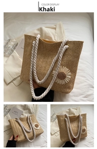 Detail of khaki woven tote bag showing V-pattern texture and daisy pendant charm
