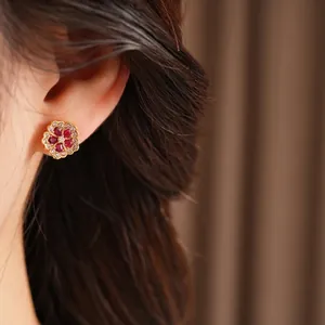Exquisite flower stud earrings with red pear-shaped gemstones in 18K gold finish