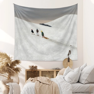 Close-up of bohemian winter snow scene tapestry hanging on white wall with modern decor