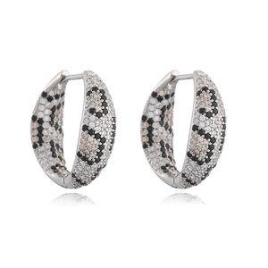 Macro detail of silver leopard print hoop earrings with paved cubic zirconia stones