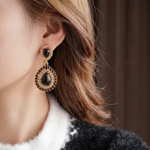 Vintage gold drop earrings with black teardrop crystals and sparkling micro-pave diamonds